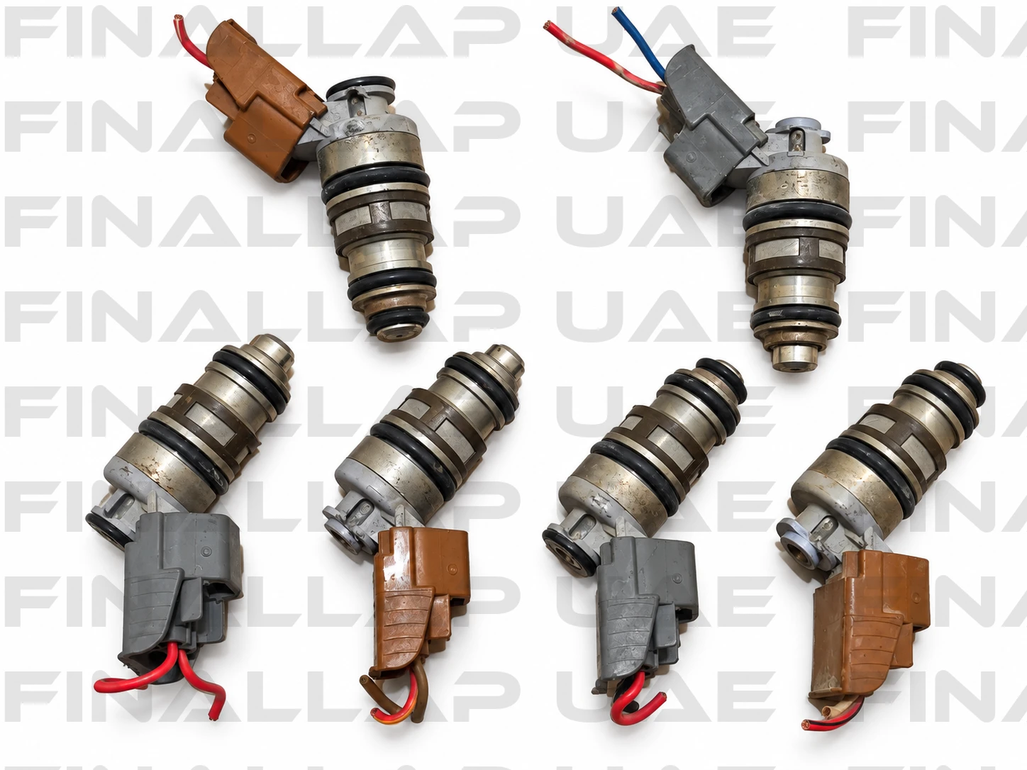 Six Used Fuel Injectors on White